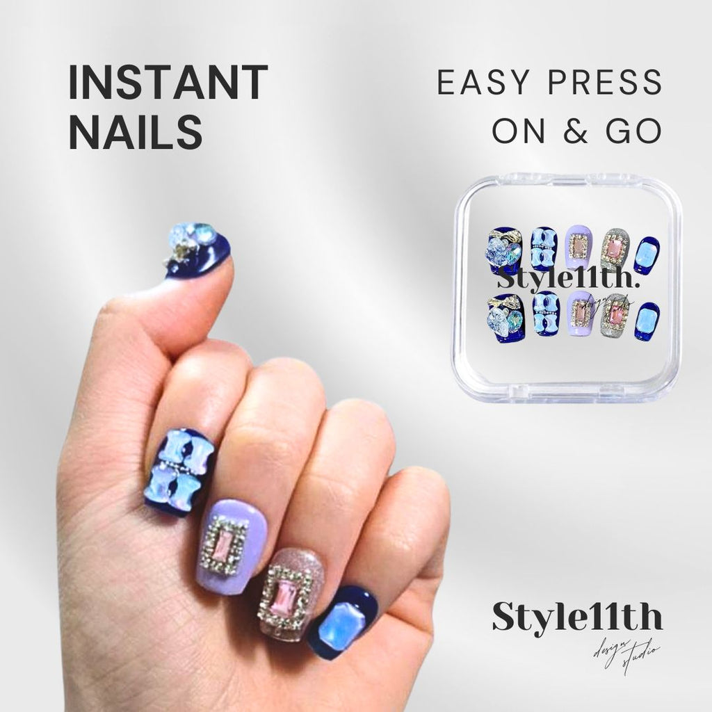 A hand displaying decorated press-on nails alongside a small clear plastic case of the same nail designs. Text on the image reads 'INSTANT NAILS', 'EASY PRESS ON & GO', and 'Style11th'.